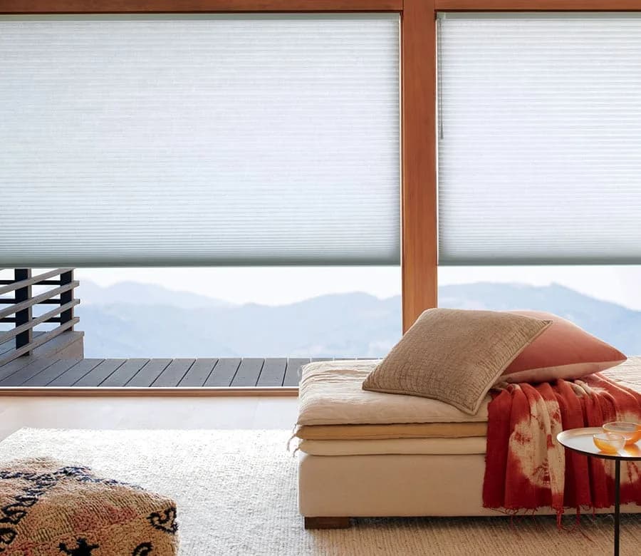 Modern living room with custom cellular shades and a mountain view